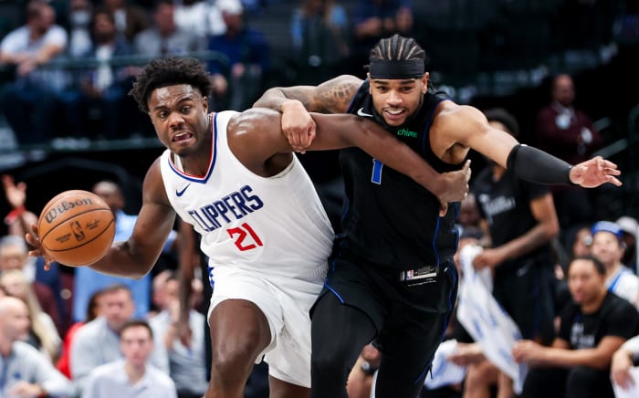 Nov 10, 2023; Dallas, Texas, USA; LA Clippers guard Kobe Brown (21) controls the ball as Dallas Mavericks guard Jaden Hardy (1) defends during the second half at American Airlines Center.